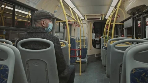 A European guy in a jacket rides an empty bus. Coronovirus in transport Stock Footage 167320785