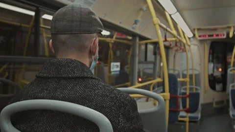 A European guy in a jacket rides an empty bus. Coronovirus in transport Stock Footage 167538442