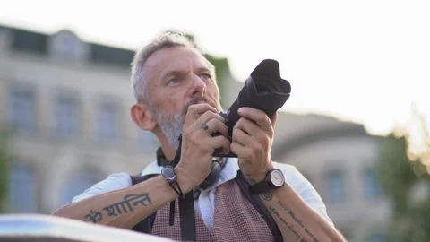 European Macho With Camera Pulls The Trigger On A Summer Evening 動画素材 125881141