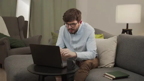 A European man puts on glasses and talks in a video link. Stock Footage 154913053