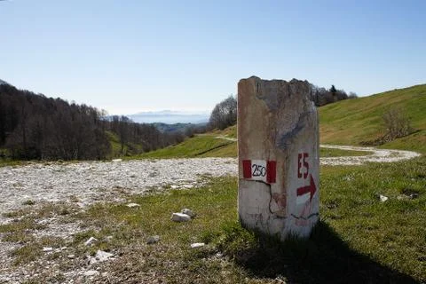 European path E5 with stone cippus and panorama of the mountains Stock Photos
