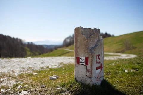 European path E5 with stone cippus and panorama of the mountains Stock Photos