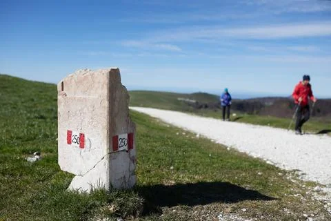 European path E5 with stone cippus and panorama of the mountains Stock Photos
