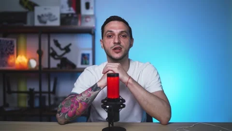 European Vlogger with Tattoos Talking to Camera in Studio Space Stock Footage 310357899