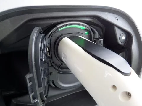 EV car, charging with green light indicator closeup Stock Photos