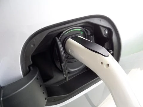 EV car, charging with green light indicator Stock Photos