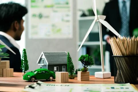 EV car model with mockup wind turbine on blurred background meeting. Quaint Stock Photos