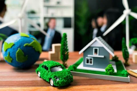 EV car model with mockup wind turbine on blurred background meeting. Quaint Stock Photos