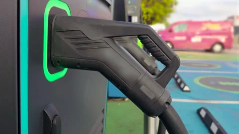 EV charging connector at public electric vehicle station with green indicator Stock Footage 345501116