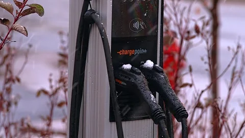 EV Charging Station in Falling Snow Stock Footage 255232568