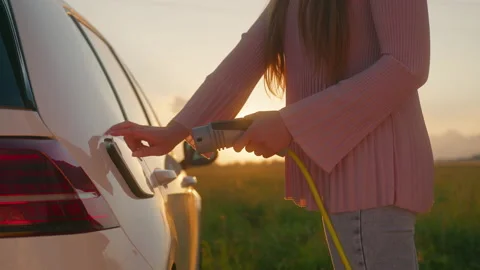 At the EV charging station at sunset Stock Footage 158896900