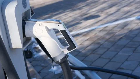 EV charging station, white plug close-up. Convenience and environmental benefits Stock-Fotos