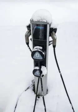 EV charging station for zero emission cars on white snow background Stock Photos