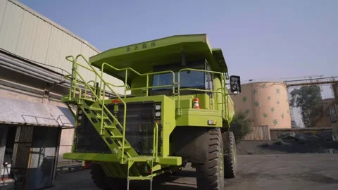An EV Mining Dump Truck standing near a factory in Pakistan. Stock Footage 332622838