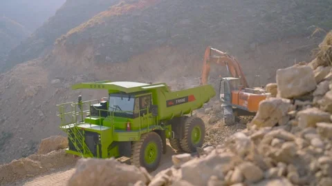 EV mining operation a TR50E electric dump truck and excavator at a surface mine Stock Footage 331792414