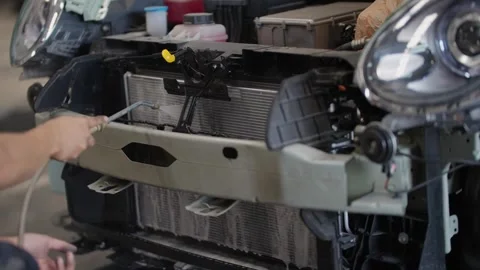 EV Technician cleans engine bay with high-pressure hose Stock Footage 339050418