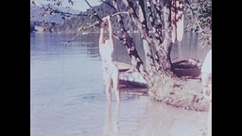 Eva Braun hangs by the tree and poses at Konigssee Stock Footage 103386227