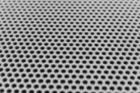 Eva rug shows a detailed pattern of holes in a surface Stockfoto's