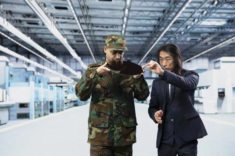 Evaluating microchip development, RD and soldier with microelectronics manager Stock Photos
