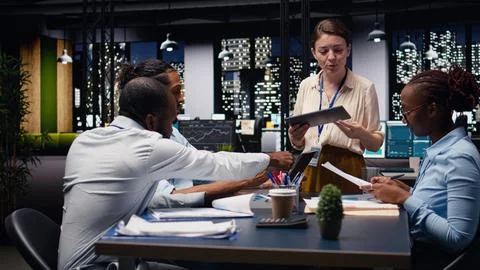 Evaluating staff performance, tablet and manager gathering employees in office Stock Photos