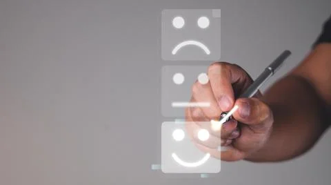 Evaluation and satisfaction concept. Someone chooses a smile emotion that is  Stock Photos
