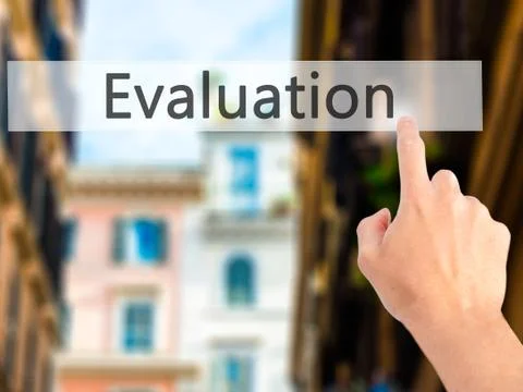 Evaluation - Hand pressing a button on blurred background concept on visual s Stock Photos