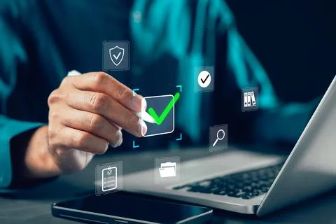 Evaluation survey by businessman using digital check mark for approval, qua.. Stock Photos