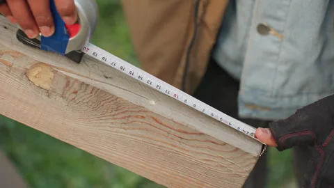 Evaluation of wood fit and precise marking outdoors. Professional assessment and Stock Footage 334954281
