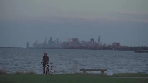 EVANSTON, USA – JANUARY 12, 2026: Cyclist Resting by Lake Michigan Stock Footage 346742753