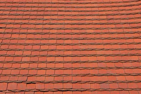 Even and uniform pattern formed by old rows of red roof tiles on a roof Stock Photos