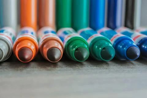 An even row of colored felt-tip pens on a sheet with space for writing Stock Photos