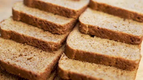 An Even Row of Slices of Black Bread. Slices of Sliced Bread for Vegetarian Toas Stock Footage 154243308