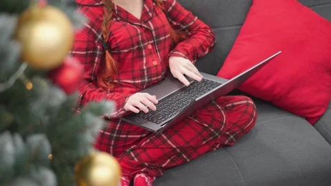 Even under the Christmas tree, in the arms of garlands and gifts, a woman makes Stock Footage 247471849