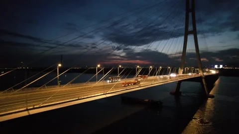 Evening aerial of cable stayed bridge and city waterfront in China Stock Footage 337684356