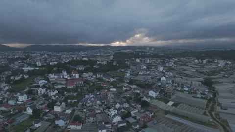 Evening aerial drone shot pulling away from Da Lat city, Vietnam Video stock 319910641