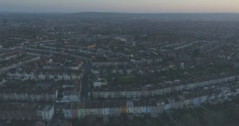 Evening aerial tracking past rows of coloured terraced suburban houses in South 스톡 동영상 108042145