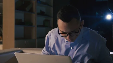 In the evening after work the young man is hardworking Stock Footage 98303561