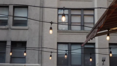 Evening Ambiance With Glowing Lanterns, Charming Rooftop Setting With Soft Glow Stock Footage 323776620