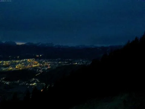 Evening and lights from a small shining city are visible in the valley Foto stock
