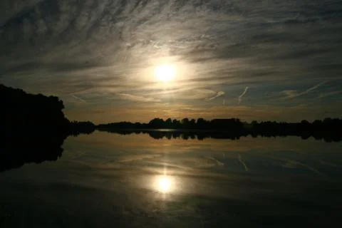 Evening atmosphere - lake -  reflection of the clouds Stock Photos