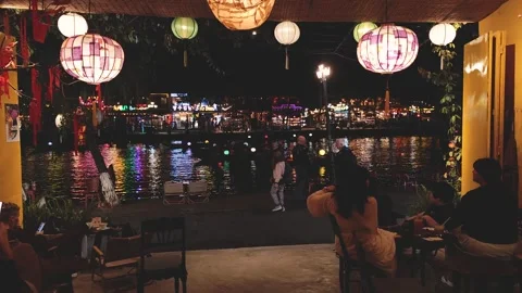 Evening atmosphere by the river with lanterns in a lively location Stock Footage 310428663
