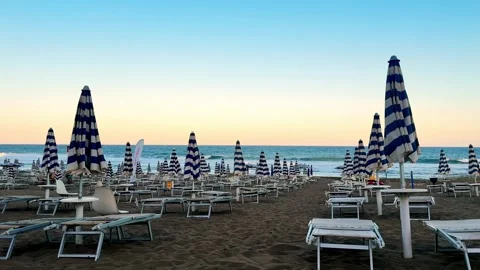 Evening beach with closed umbrellas and loungers Stock Footage 319549028