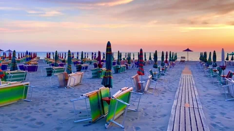 Evening beach. Neat rows of folded umbrellas. Sunset. Stock Footage 246330331