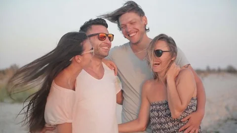 Evening at the Beach. Portrait of Four Friends Having Fun Together on the Stock Footage 80534522