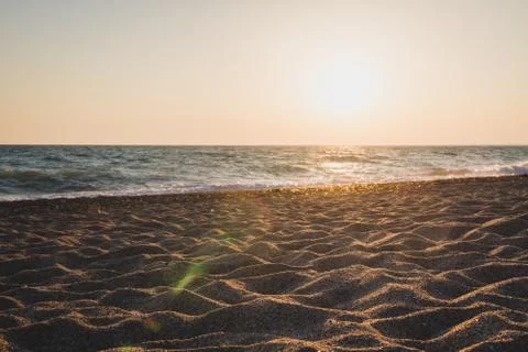 Evening beach at sunset in summer Stock Photos