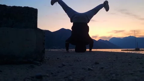 Evening Beach Yoga - Headstand with Sunset and Mountain View Stock Footage 237996785
