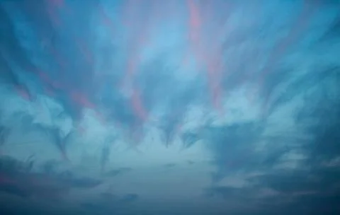 Evening blue cloudy sunset sky Stock Photos