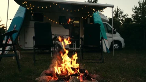 Evening bonfire close-up on the background of a motorhome Stock Footage 256632034