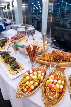 Evening buffet feast!. An array of appetizers and main dishes is elegantly .. Stock Photos