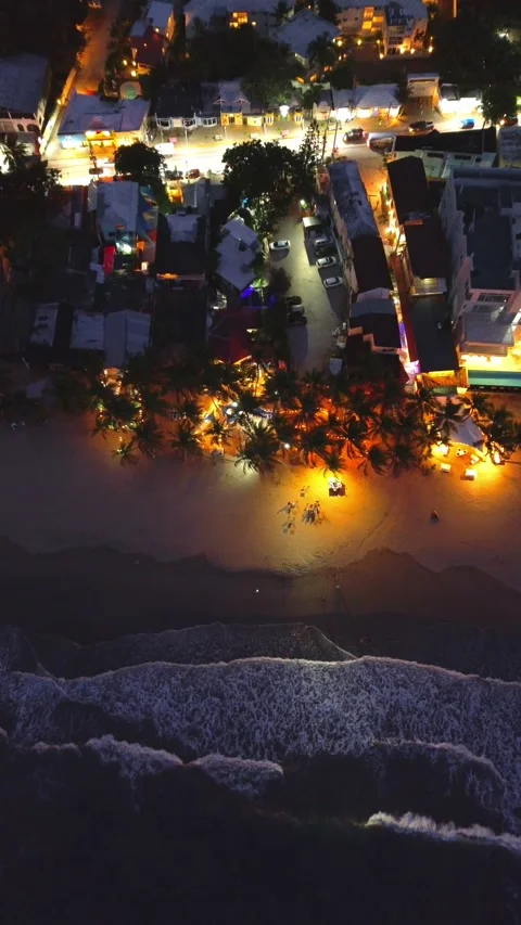 Evening Cabarete Beach with Palm Trees and Illuminated Restaurants. Aerial View Stock Footage 314866493